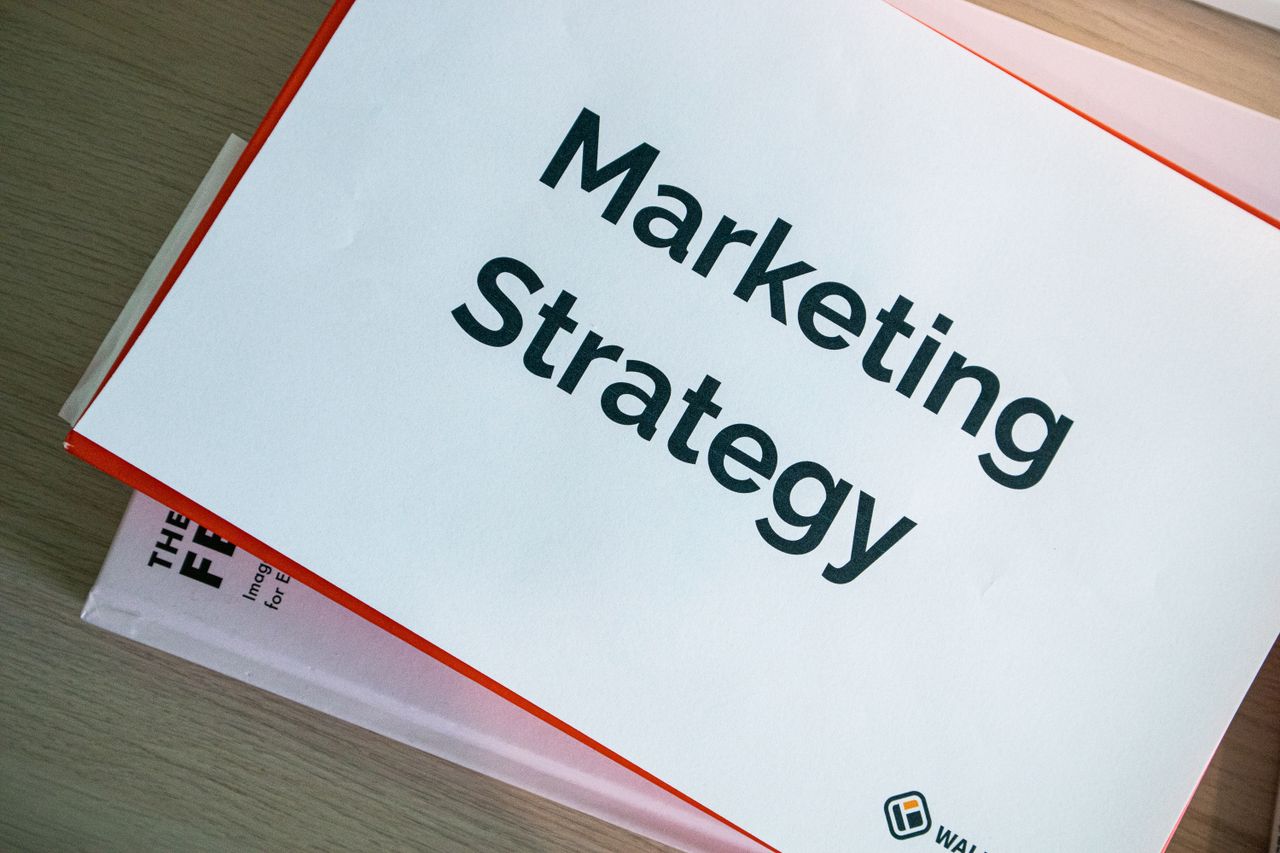 services-01 A marketing strategy document displayed on a desk, showcasing business planning essentials.